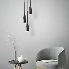 Water drop pendant light hanging over a styled interior setting