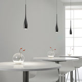 Teardrop pendant light casting soft warm light in a modern room