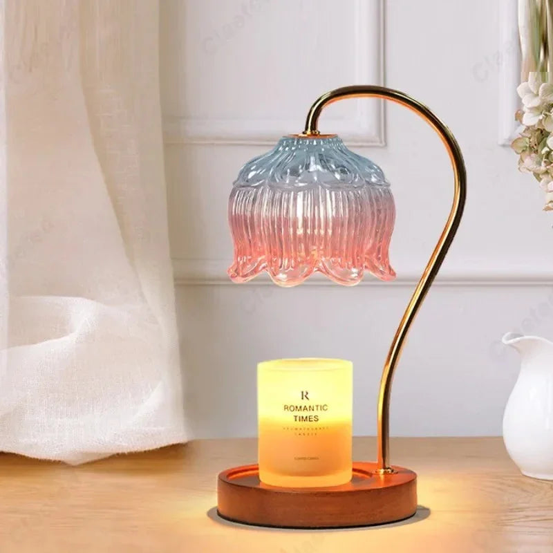 Wax melting lamp with a gradient glass shade beside a sheer curtain and jug