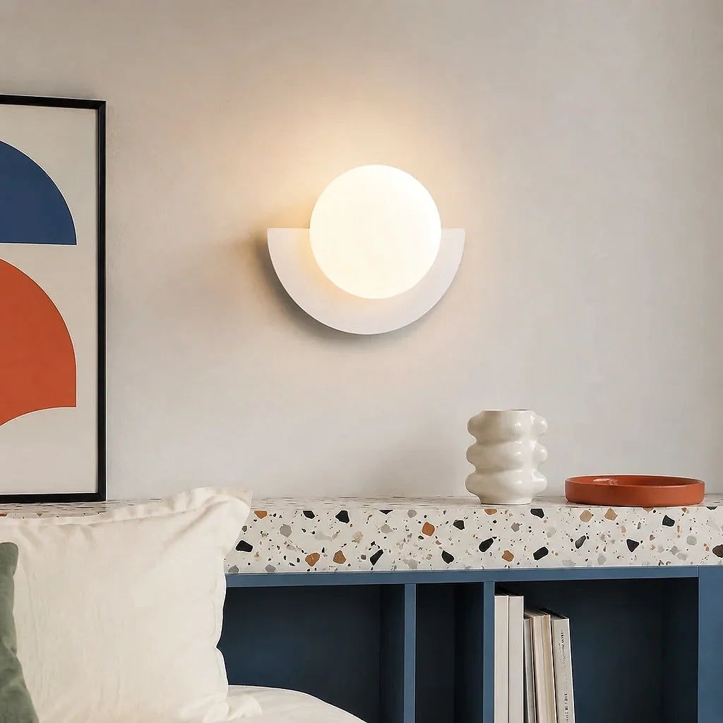 White half moon wall sconce with a clean frosted glass globe shade