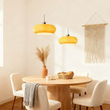 Close-up of a white oval glass shade with a brushed metal ceiling cap