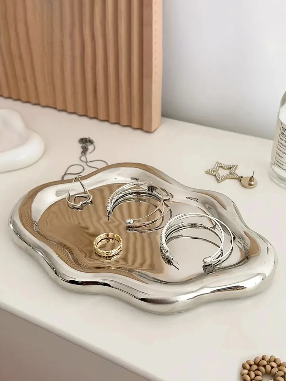 White jewelry display trays arranged on dresser surface
