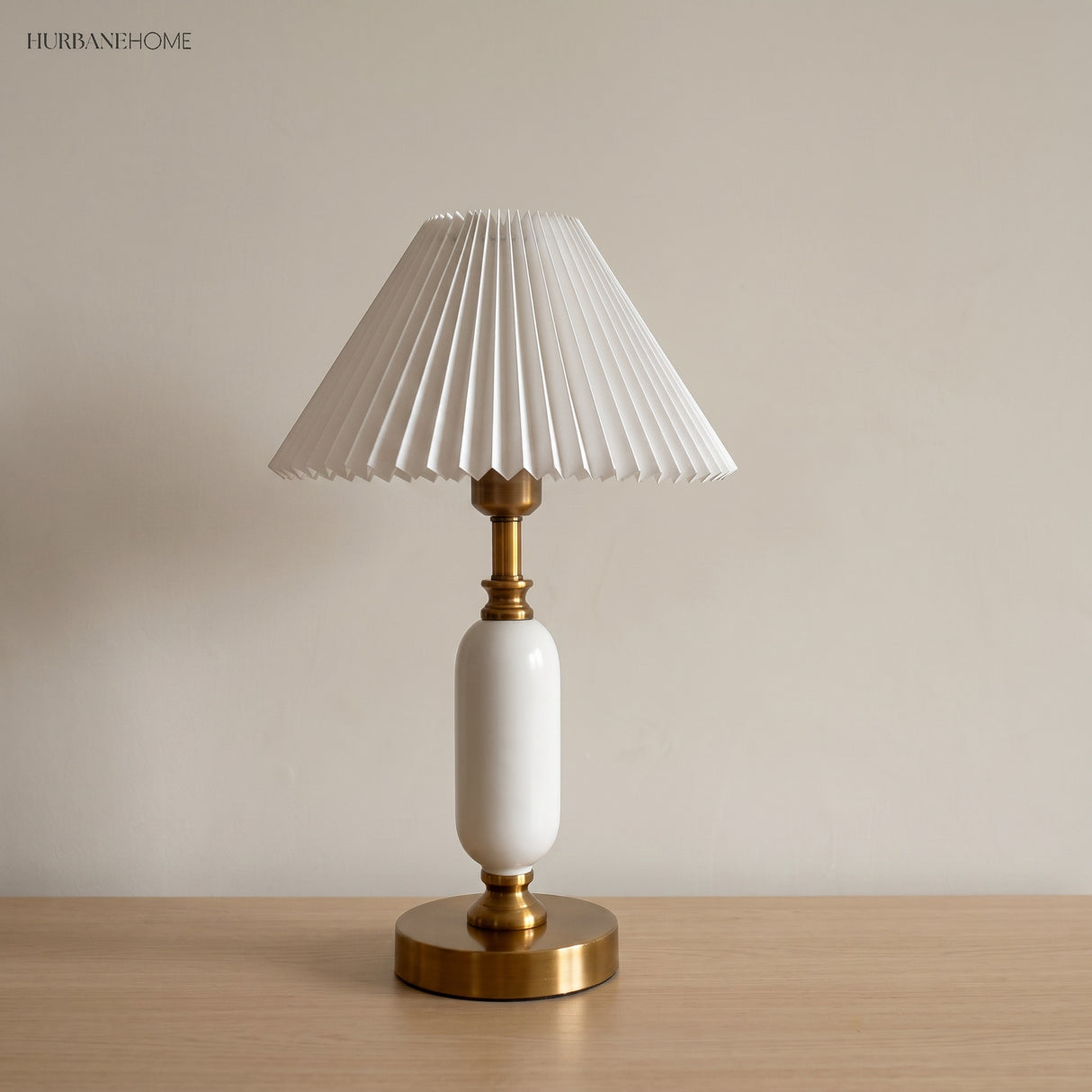 White pleated shade lamp with glossy white column and brass base