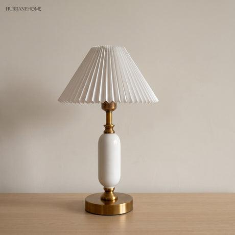 White pleated shade lamp with glossy white column and brass base