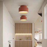 White fluted semi flush mount ceiling light on a plain studio background