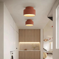 White fluted semi flush mount ceiling light on a plain studio background