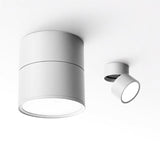 Two white spot lights shown at different tilt angles on a pale background