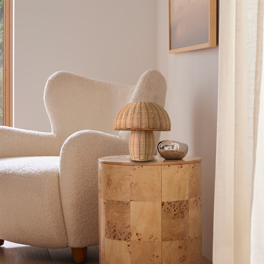 Wicker mushroom table lamp shown at an angle on a plain background