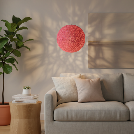 Pink woven globe pendant on a white cord