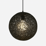 Black woven globe pendant lit against a plain white backdrop