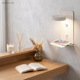 Black wall lamp lighting a book on the shelf in a living space