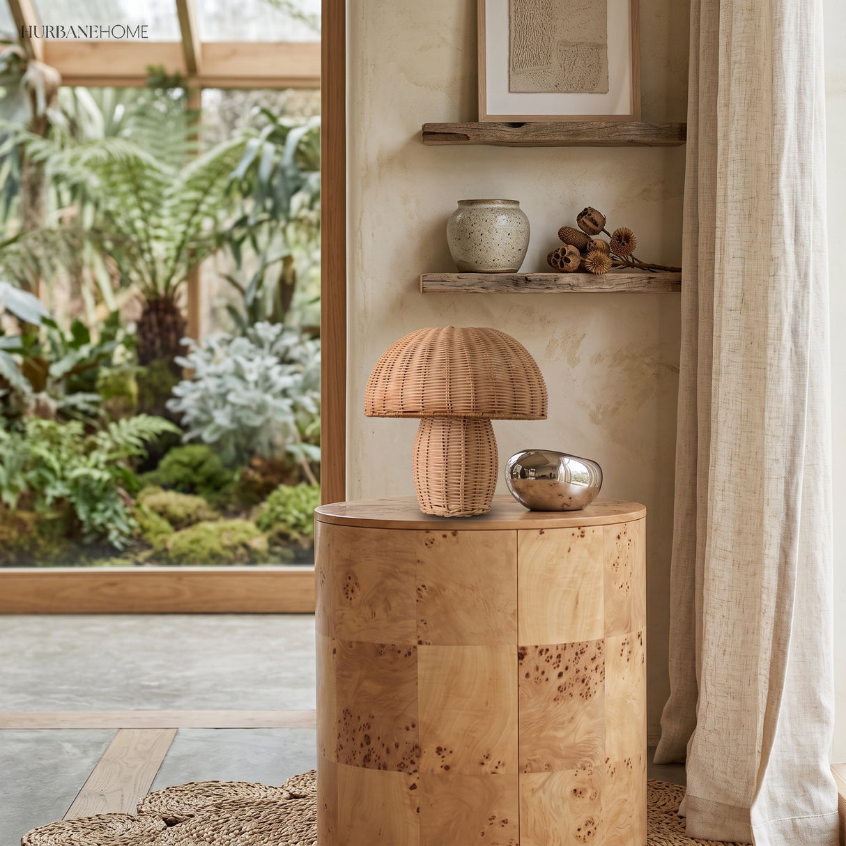 Mushroom wicker table lamp on a burl-wood table in a sunlit room