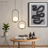 Black Oval Frame Glass Globe Pendant Light in a bedroom setting