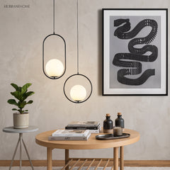 Black Oval Frame Glass Globe Pendant Light in a bedroom setting