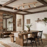 Wood beam track light with five heads above a rustic timber dining table