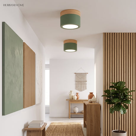Two green ceiling lights lit in a hallway with timber slats