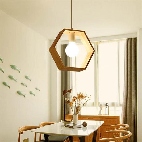 Hexagon wood pendant lit above a dining table set with flowers