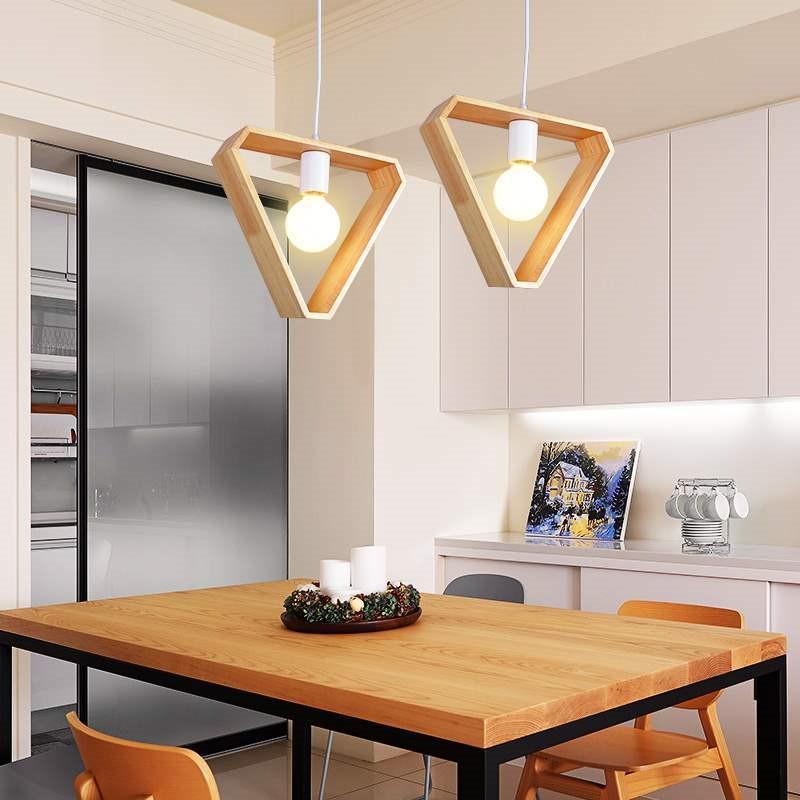 Hexagon and triangle wood pendant lights hanging over a kitchen table