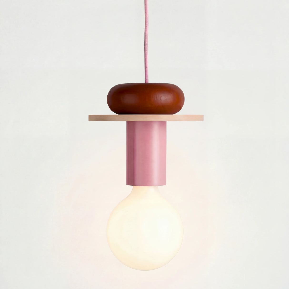 Multicolor geometric wood pendant light shown against a plain studio background