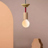 Handmade multicolor pendant light with wood forms in a warm interior view