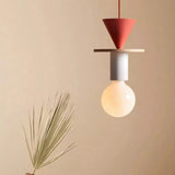 Modern wood pendant light with painted geometry over a styled tabletop scene