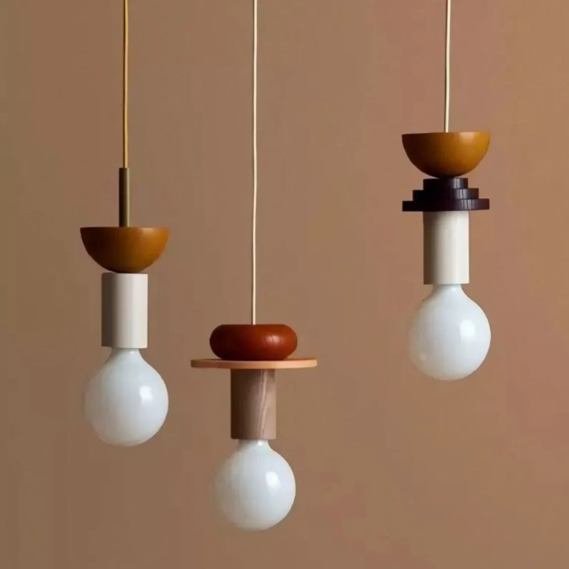 Wood and painted pendant light suspended in a bright minimalist dining area