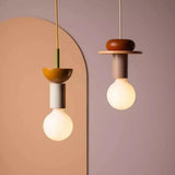 Wood pendant light with stacked painted shapes styled in a modern room scene
