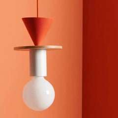 Ash wood geometric pendant light casting warm light in a relaxed lounge