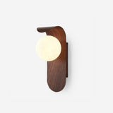 Wood tone wall sconce with frosted glass globe studio front view