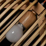 Close view of the bulb and wood lamp holder inside the shade
