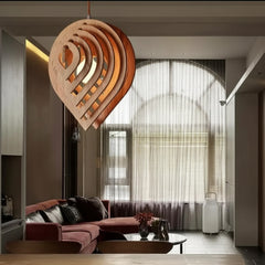 Wood teardrop pendant lit above a lounge with a pink sofa