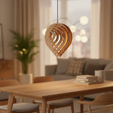 Layered wood teardrop pendant lit warm against a black background
