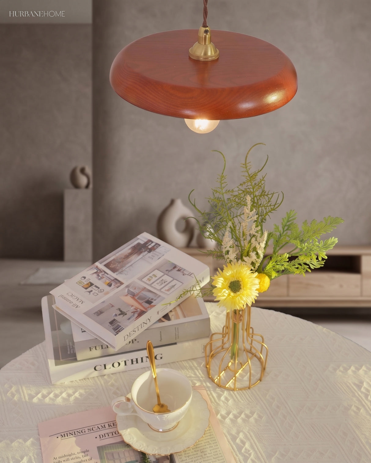 Wood pendant hung above a small side table with a vase of yellow flowers