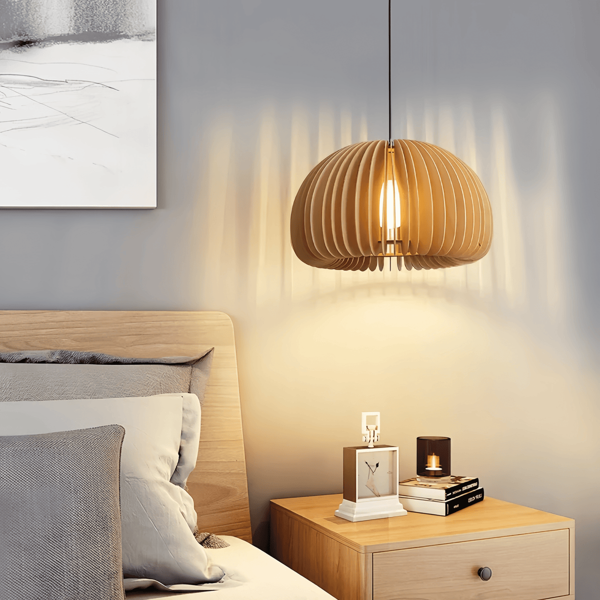 Wood dome pendant lit above a bedside table in a neutral bedroom