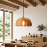 Wood slat dome pendant above a dining table under timber ceiling beams