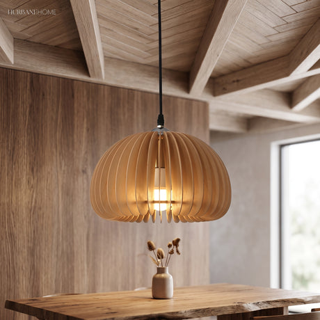 Wood slat dome pendant lit above a table under a timber ceiling
