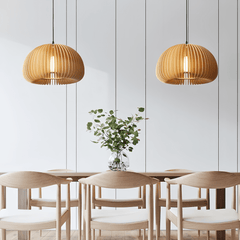 Two wood dome pendants above a pale wood dining table and chairs