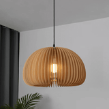 Wood slat dome pendant seen lit from below against white