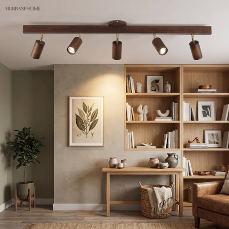 Oak track lighting bar above a living room with open shelving and plants