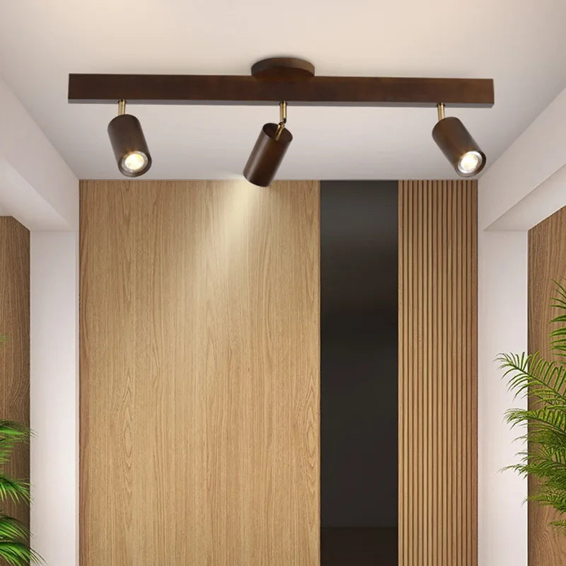 Walnut track bar on a ceiling above a wood panelled doorway