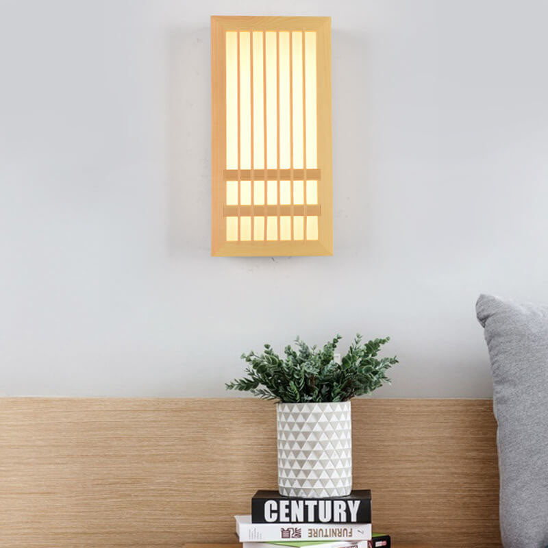Natural wood wall sconce glowing in a bedroom beside a curtain and nightstand