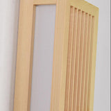 Detail of the light wood frame, slats and acrylic diffuser panel unlit