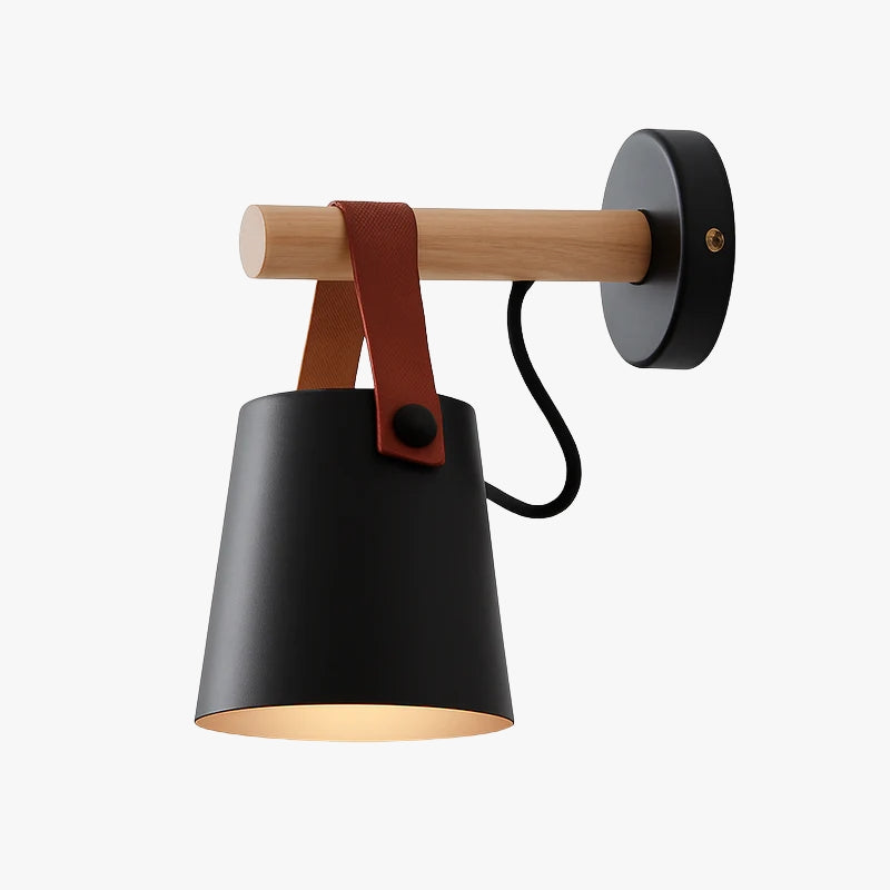 Black sconce with the shade slung from a strap on the arm