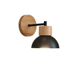Wood sconce with a black iron dome on a plain white background