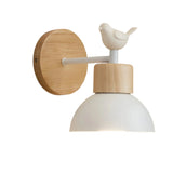 Wood sconce with a white dome and a perched bird on the arm