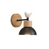 Wood sconce with a white dome and a bird figure on the arm