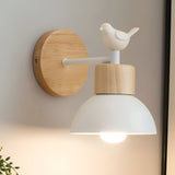 White domed wood sconce with a bird figure beside a framed print