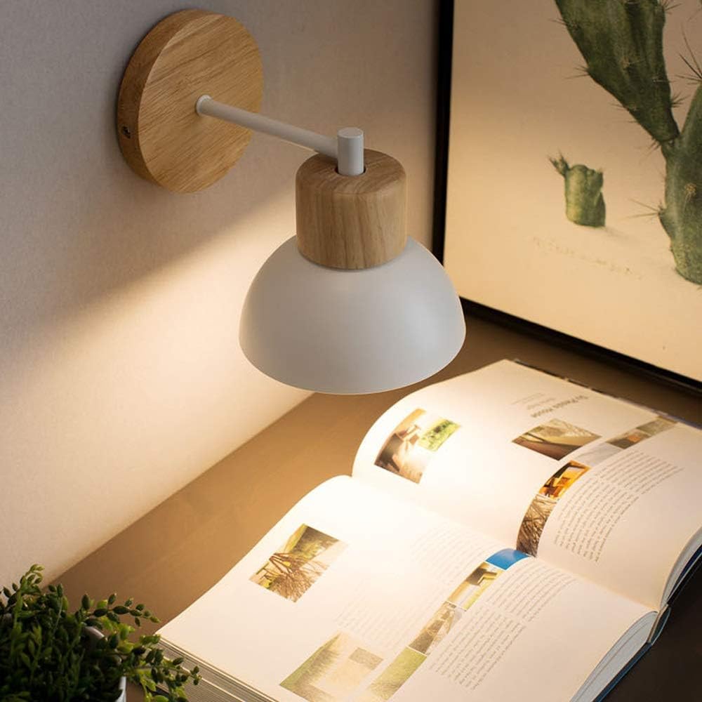 White domed wood sconce lit above an open magazine