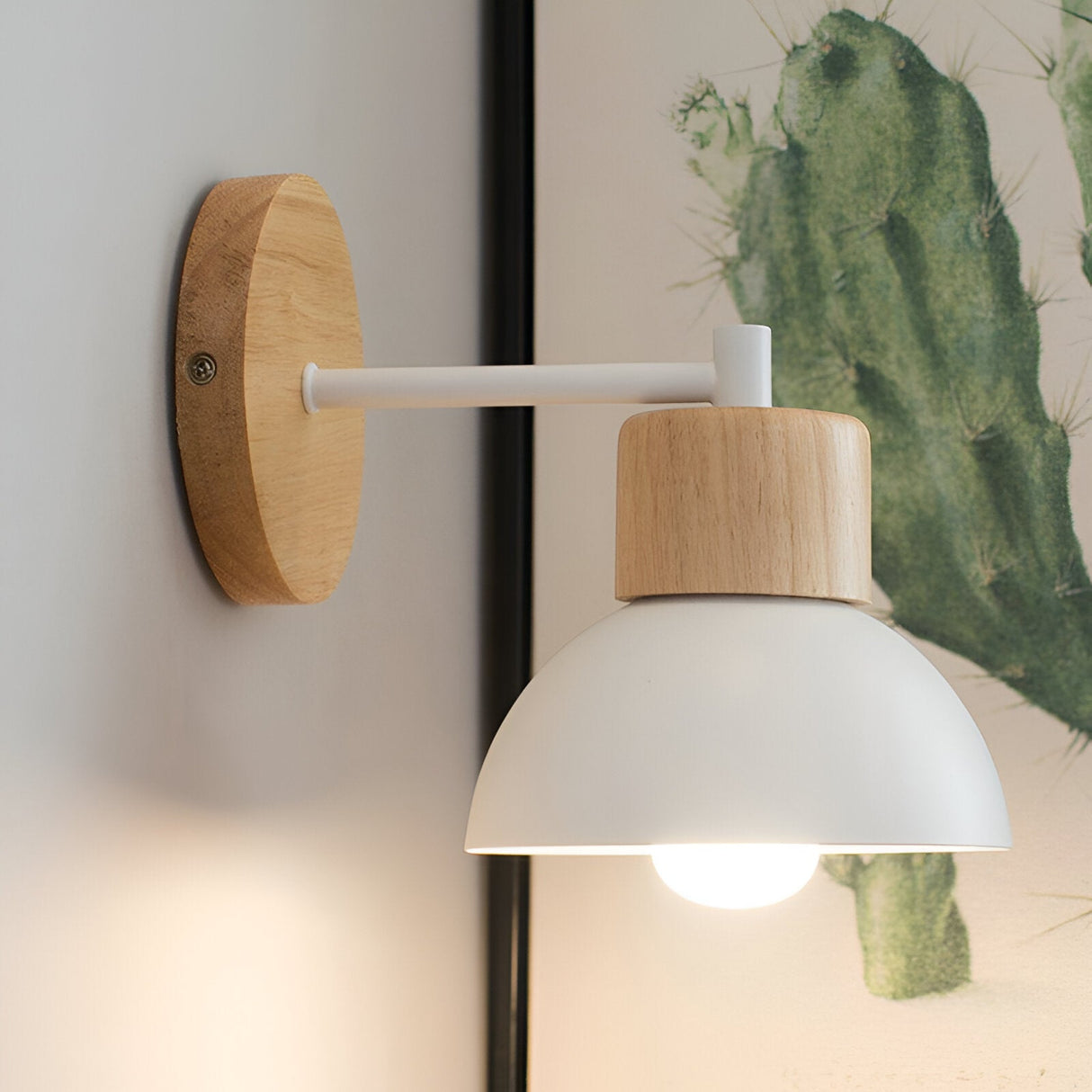 White domed wood sconce lit against a plain pale wall