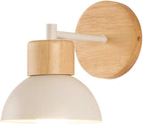 Wood sconce with a white dome shown from a low angle